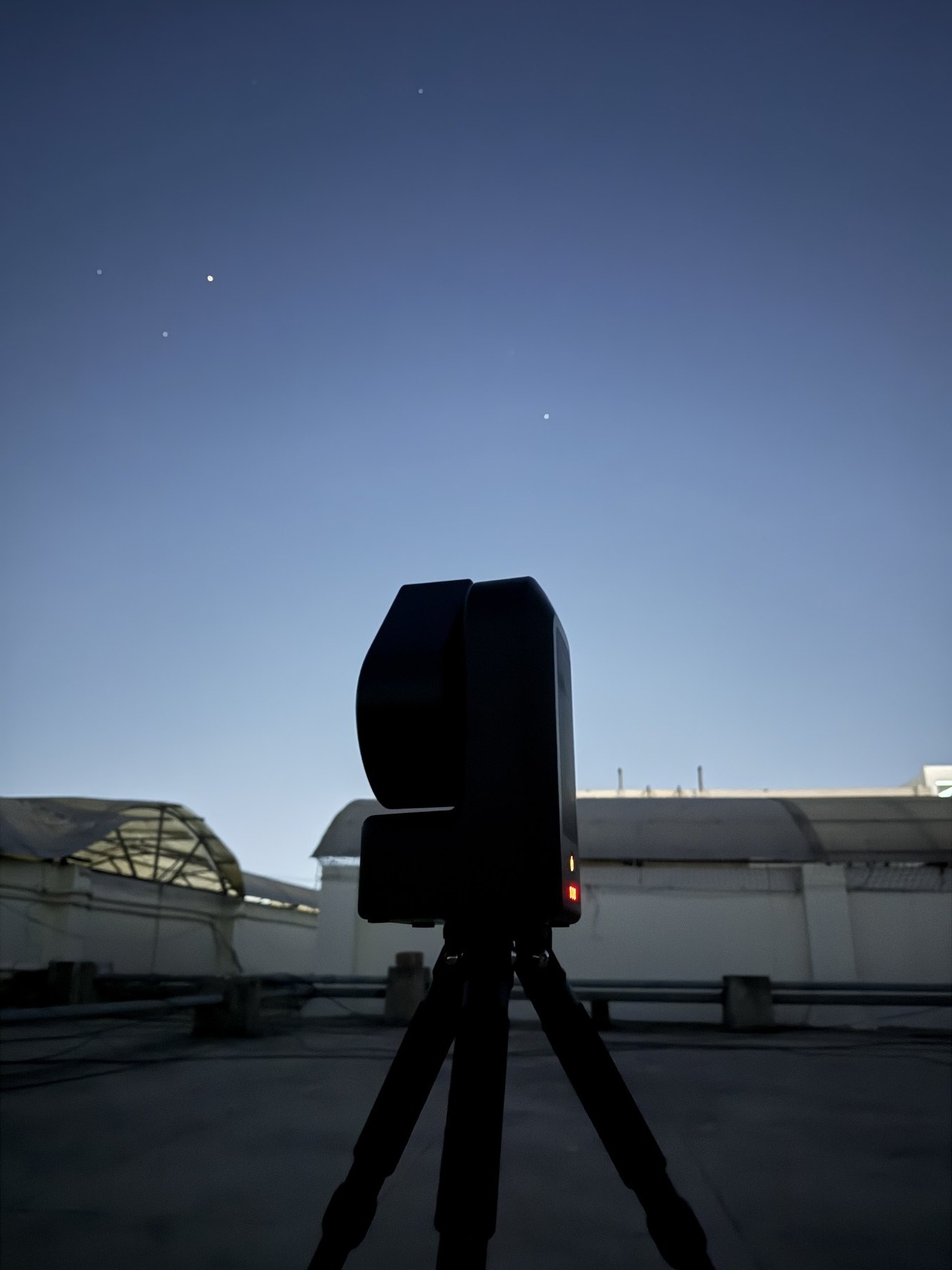 A Seestar smart telescope set up outdoors at dusk